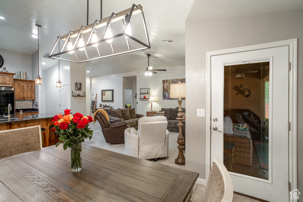 Dining area with vaulted ceiling, sink, and ceiling fan