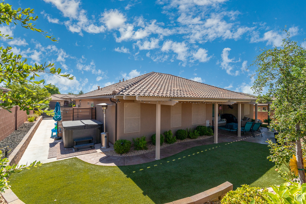 Back of property featuring a patio and a yard