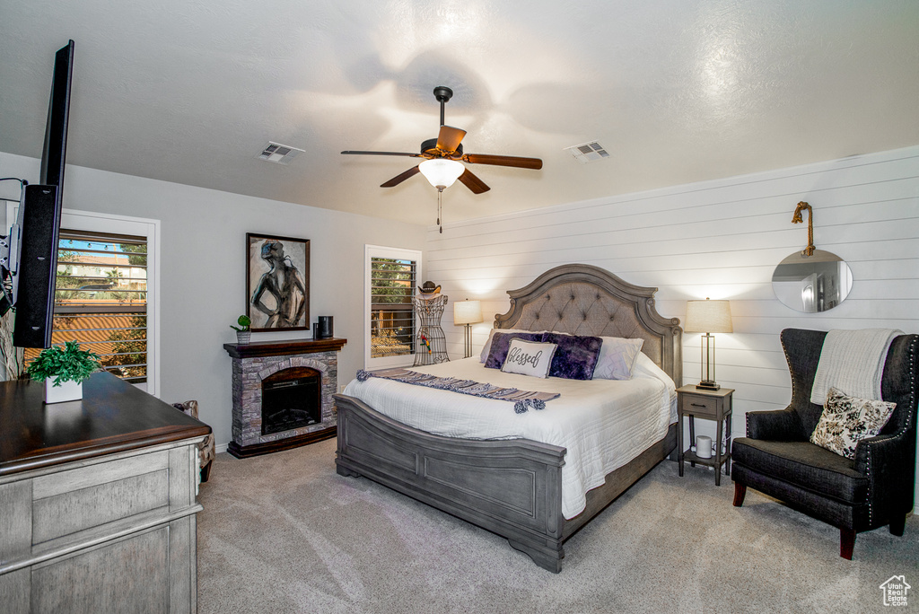 Bedroom with multiple windows, ceiling fan, and light colored carpet