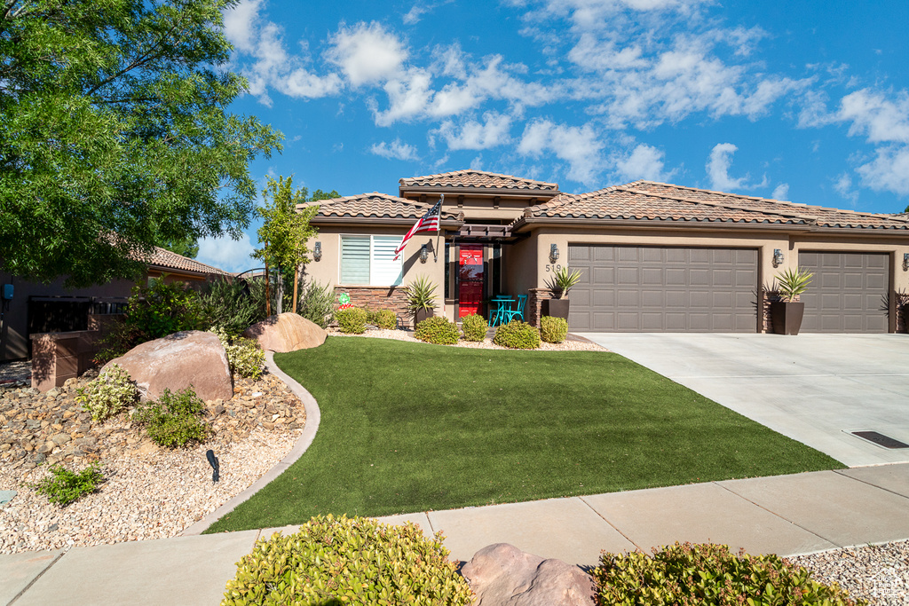 View of front of home featuring a garage and a front yard