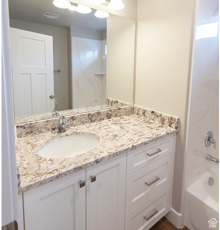 Bathroom with vanity and shower / bathing tub combination