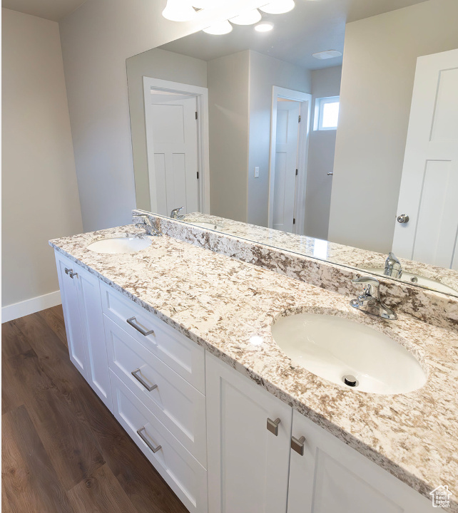 Bathroom featuring double sink vanity and hardwood / wood-style floors