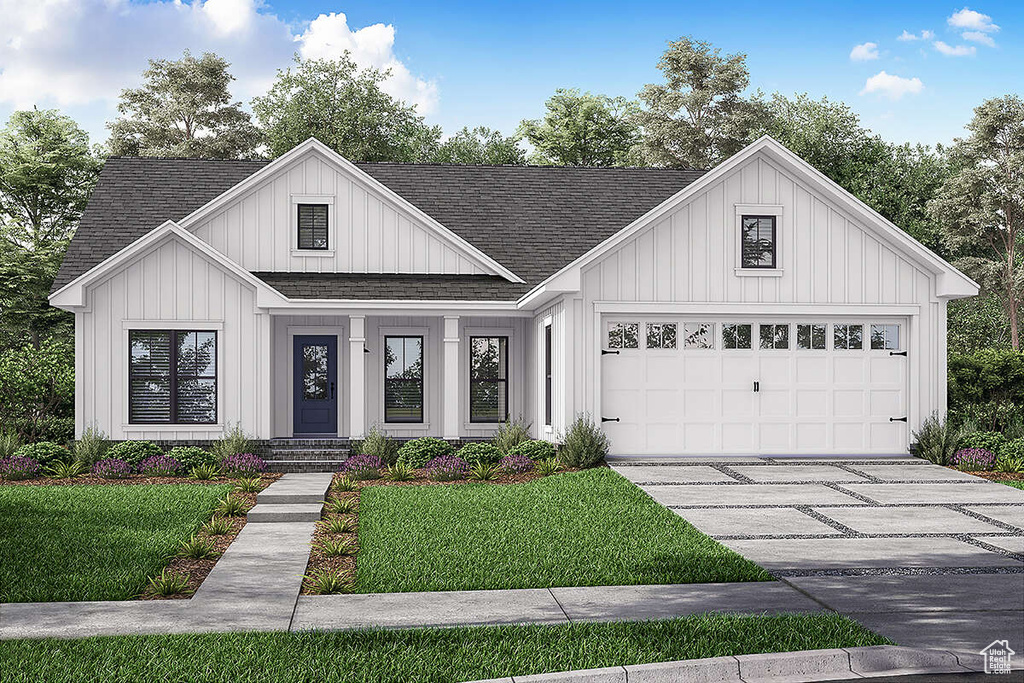 Modern inspired farmhouse with a garage and a front lawn