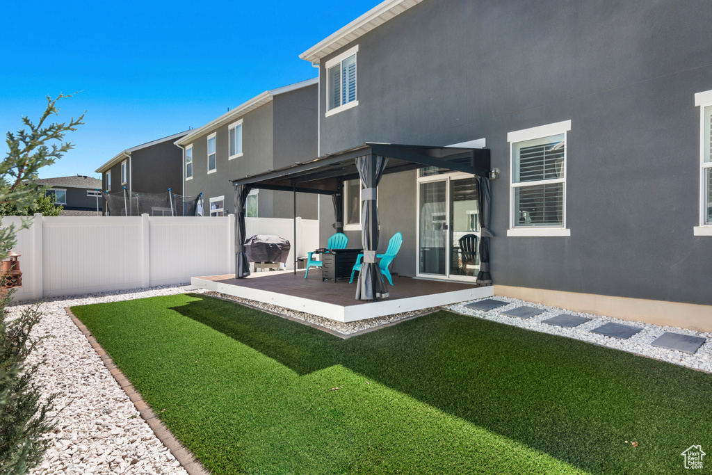 Rear view of house featuring a yard and a patio area