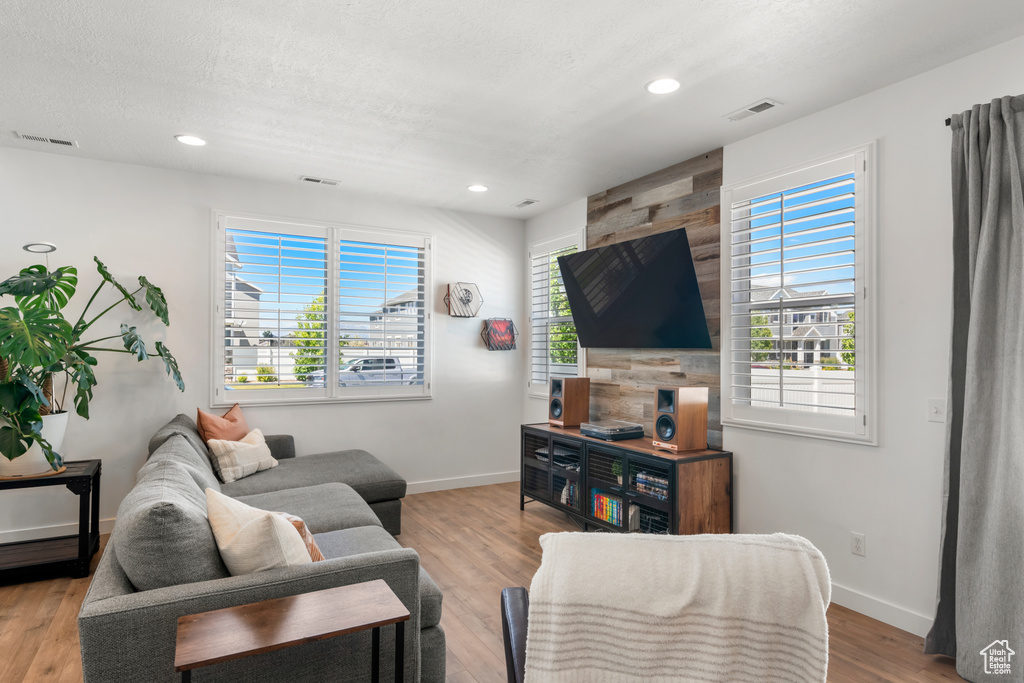 Living room with hardwood / wood-style flooring and a wealth of natural light