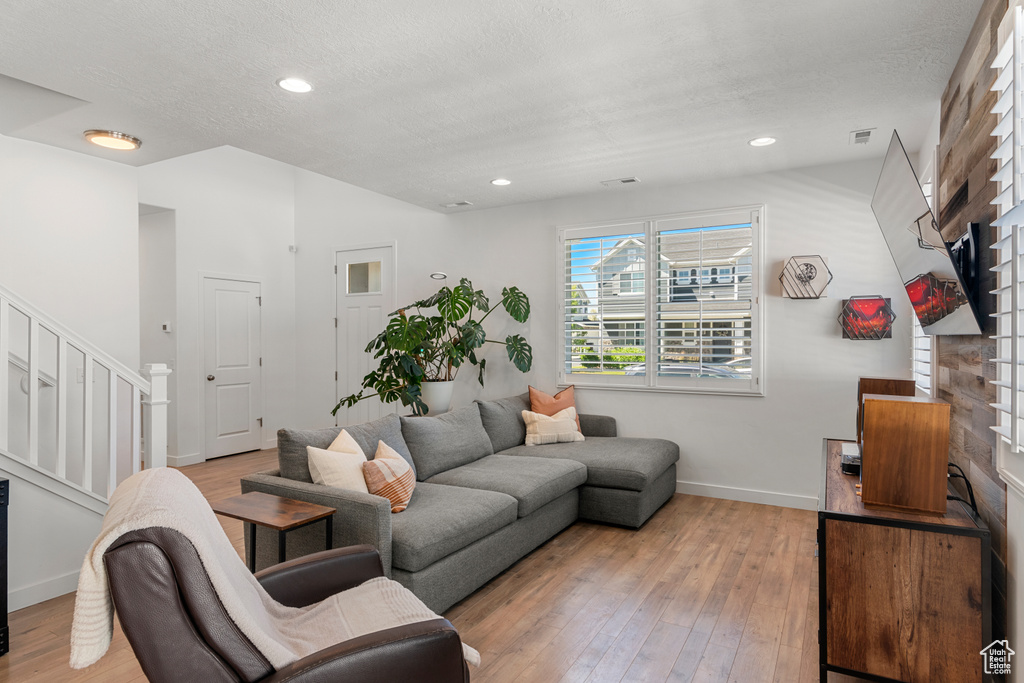 Living room with hardwood / wood-style flooring