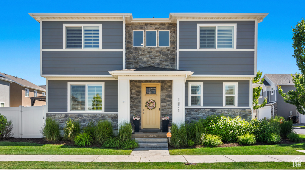 View of front of property with a front yard