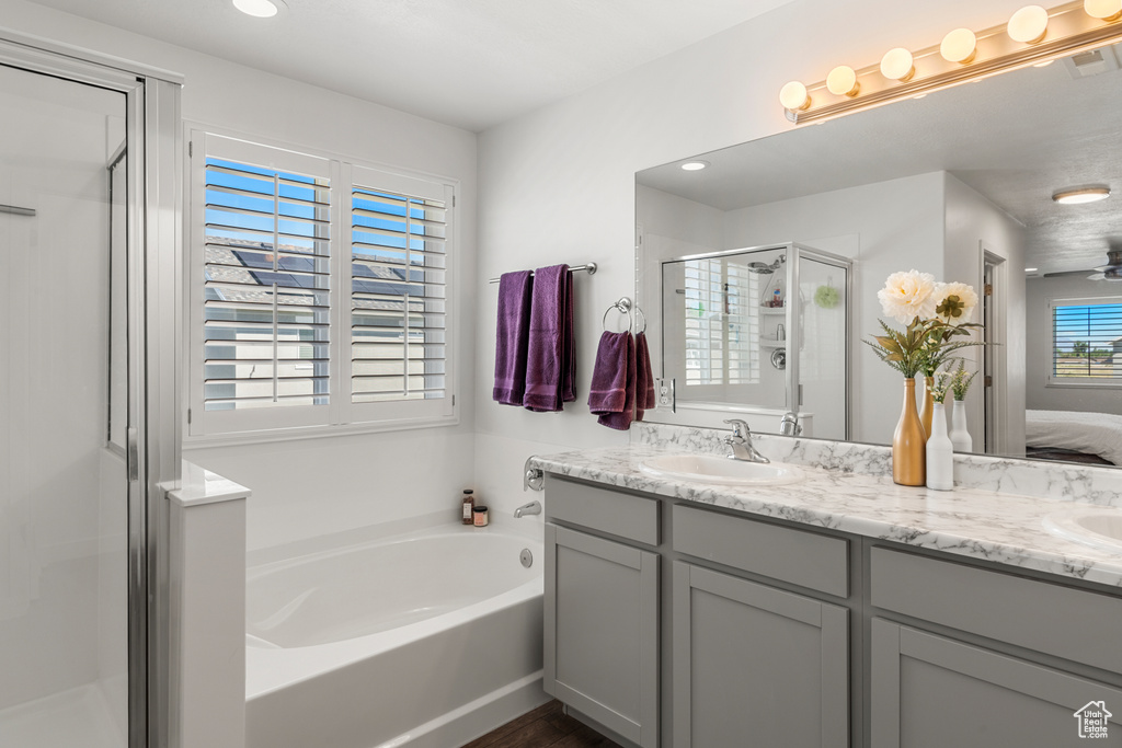 Bathroom with double sink, separate shower and tub, and large vanity