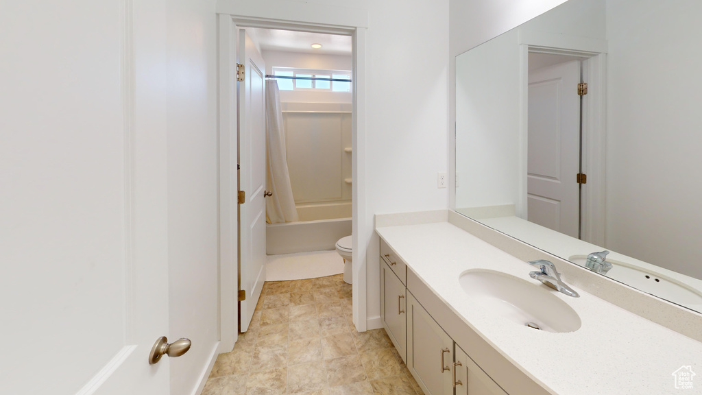 Full bathroom with vanity, shower / tub combo, toilet, and tile patterned floors