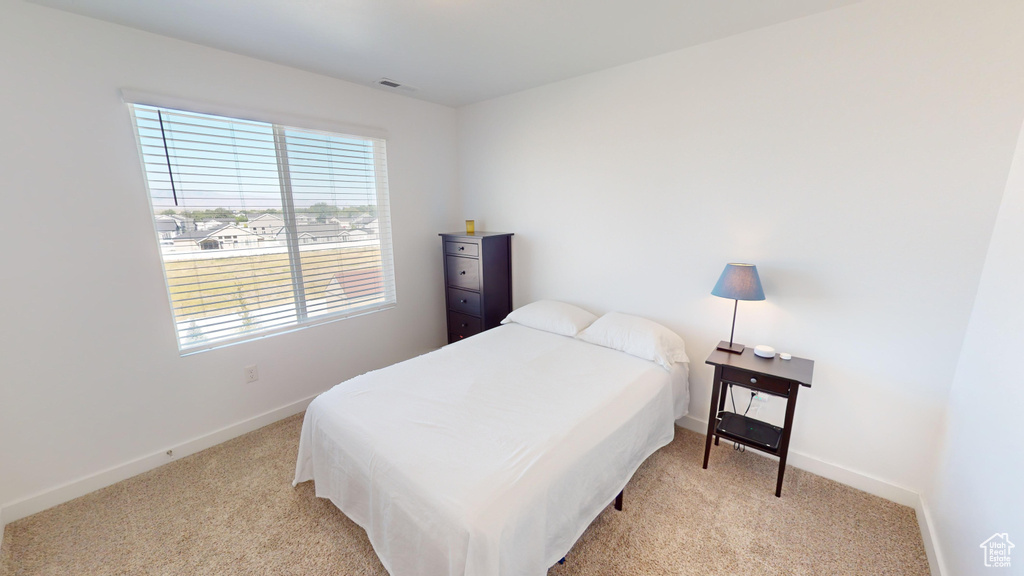 Bedroom with light carpet