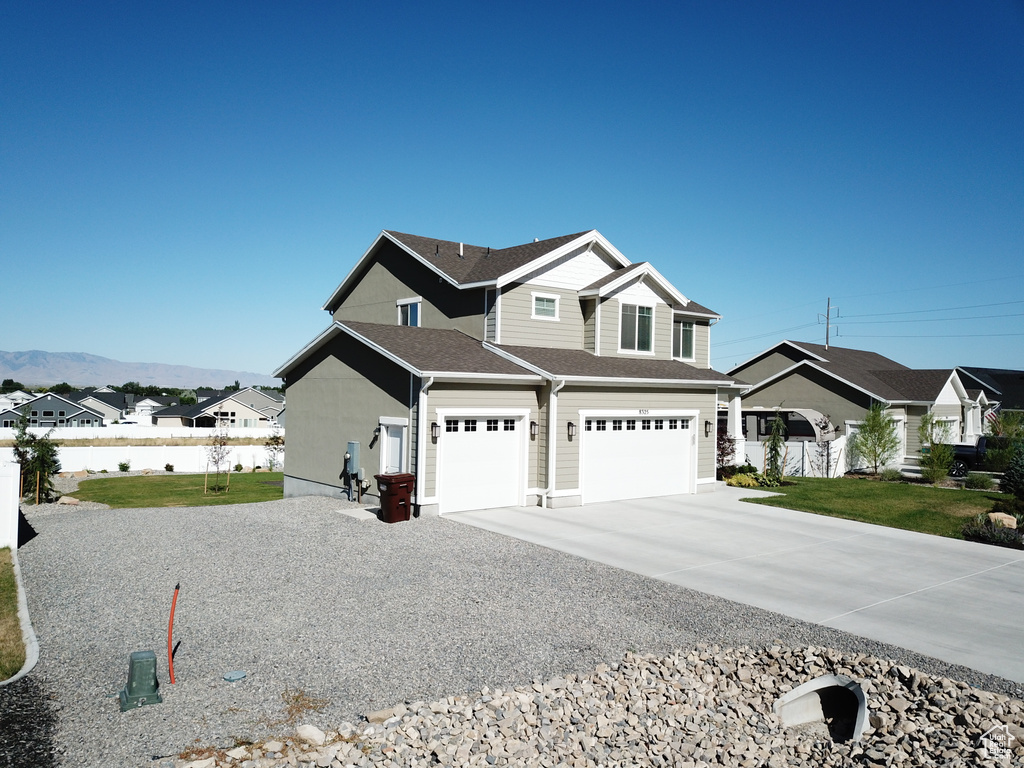 View of front facade featuring a mountain view and a garage