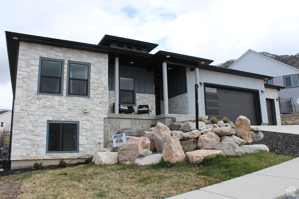 View of front facade featuring a garage