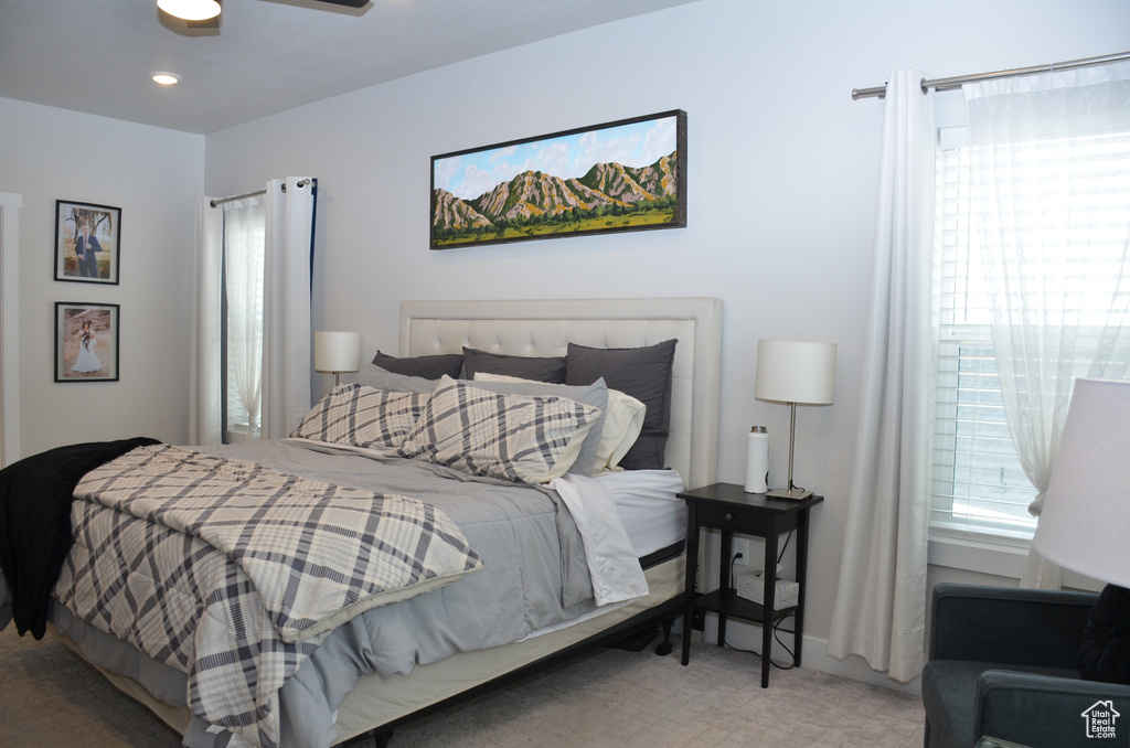 Carpeted bedroom with ceiling fan