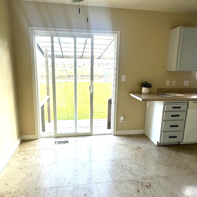 Interior space with plenty of natural light and light tile patterned floors