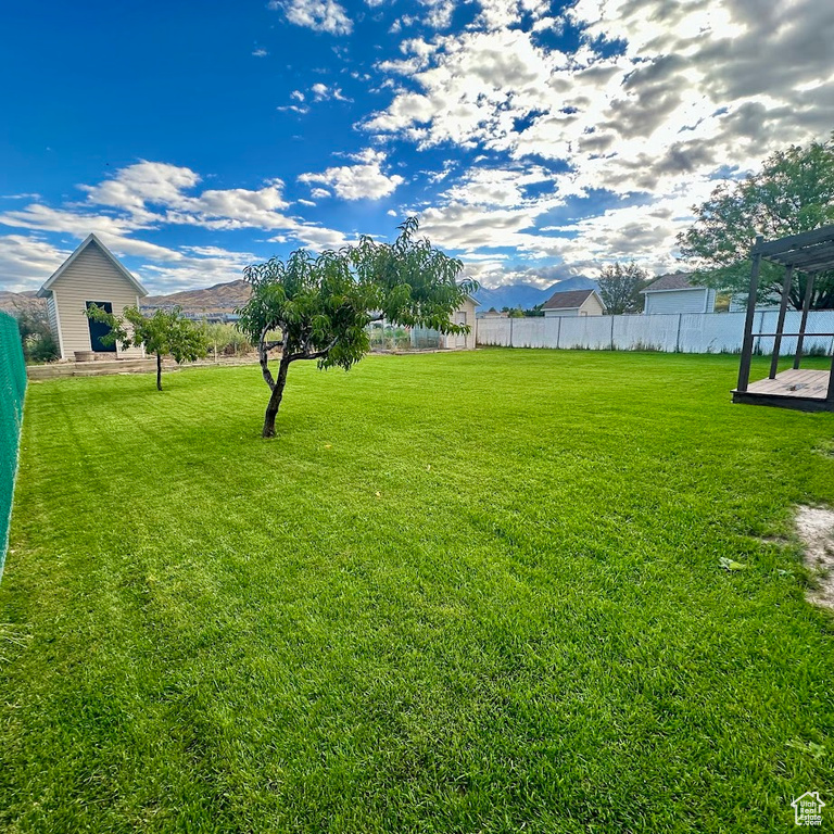 View of yard with a wooden deck