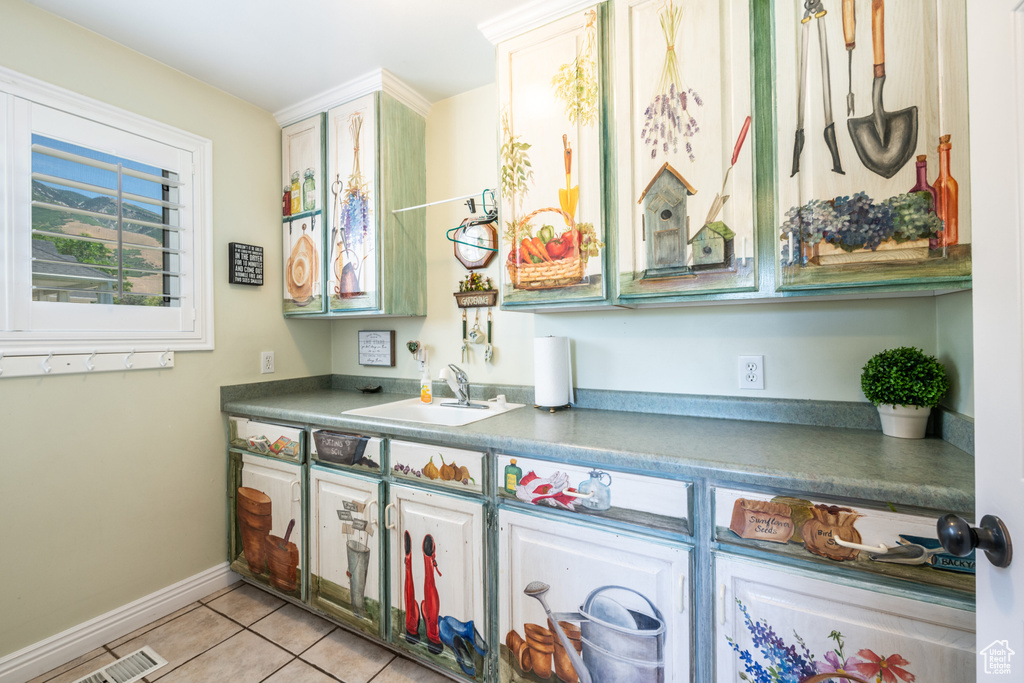 Kitchen with light tile patterned flooring and sink