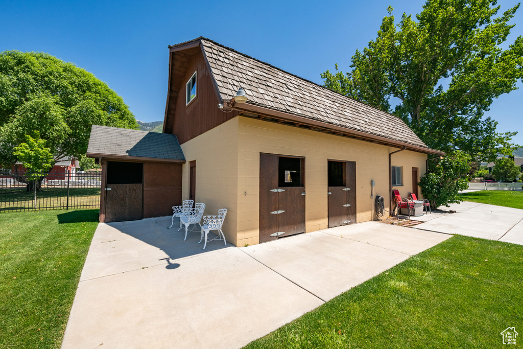 View of front of property with a patio area and a front yard