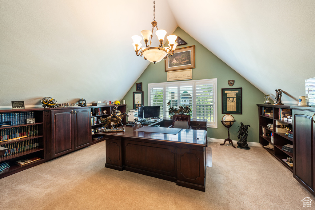 Office with a chandelier, light carpet, and vaulted ceiling