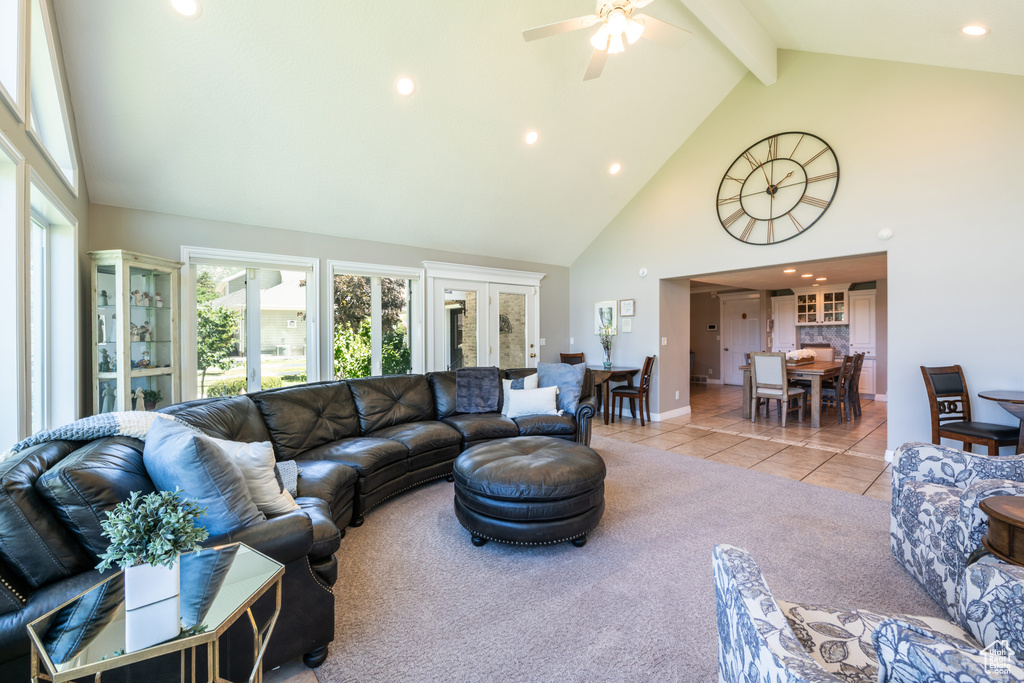 Living room with beamed ceiling, tile patterned flooring, french doors, high vaulted ceiling, and ceiling fan