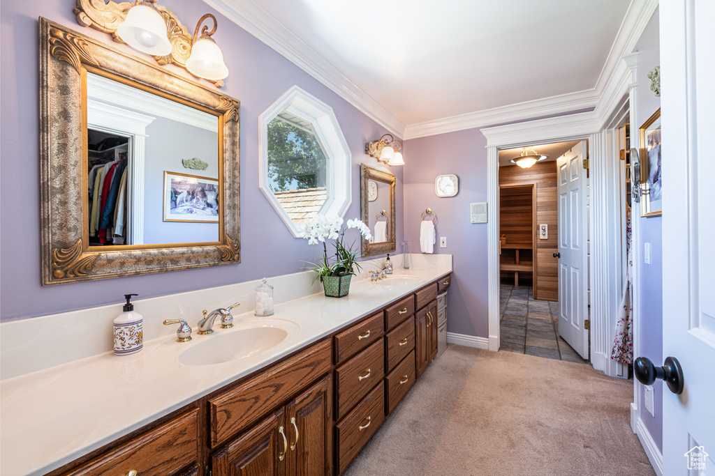 Bathroom with tile patterned flooring, ornamental molding, and double sink vanity