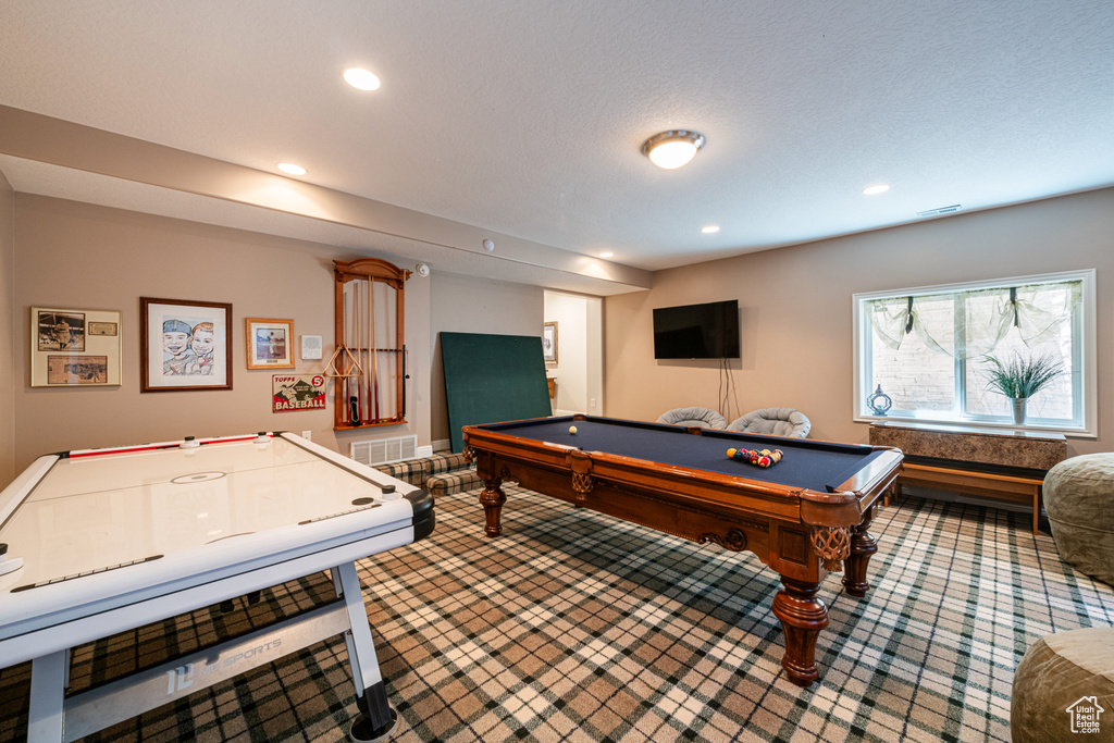 Playroom featuring pool table, carpet floors, and a textured ceiling