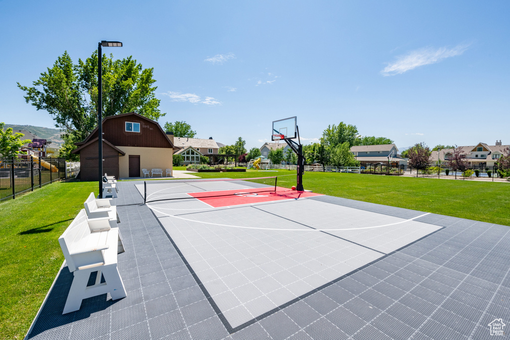 View of sport court featuring a yard