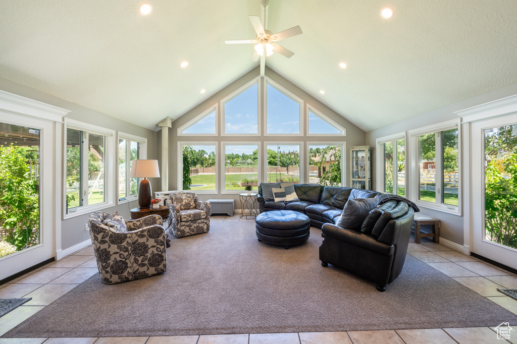 Sunroom featuring lofted ceiling, a wealth of natural light, and ceiling fan