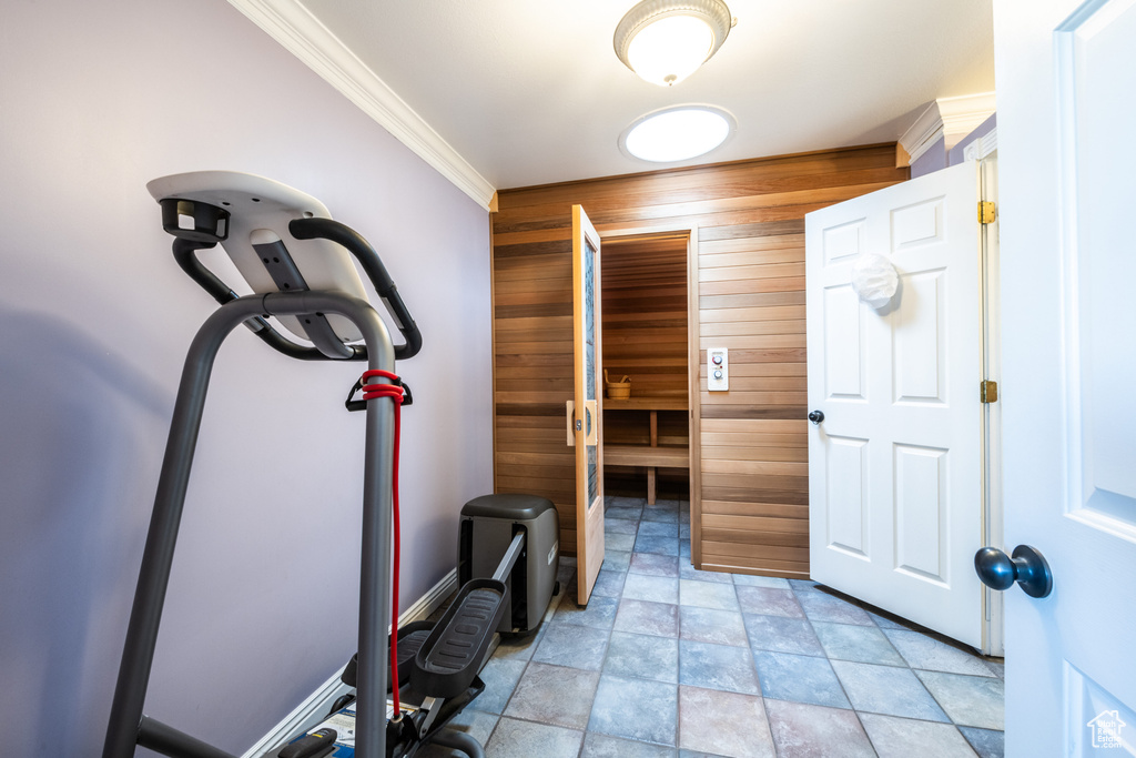 Workout room with light tile patterned floors and ornamental molding