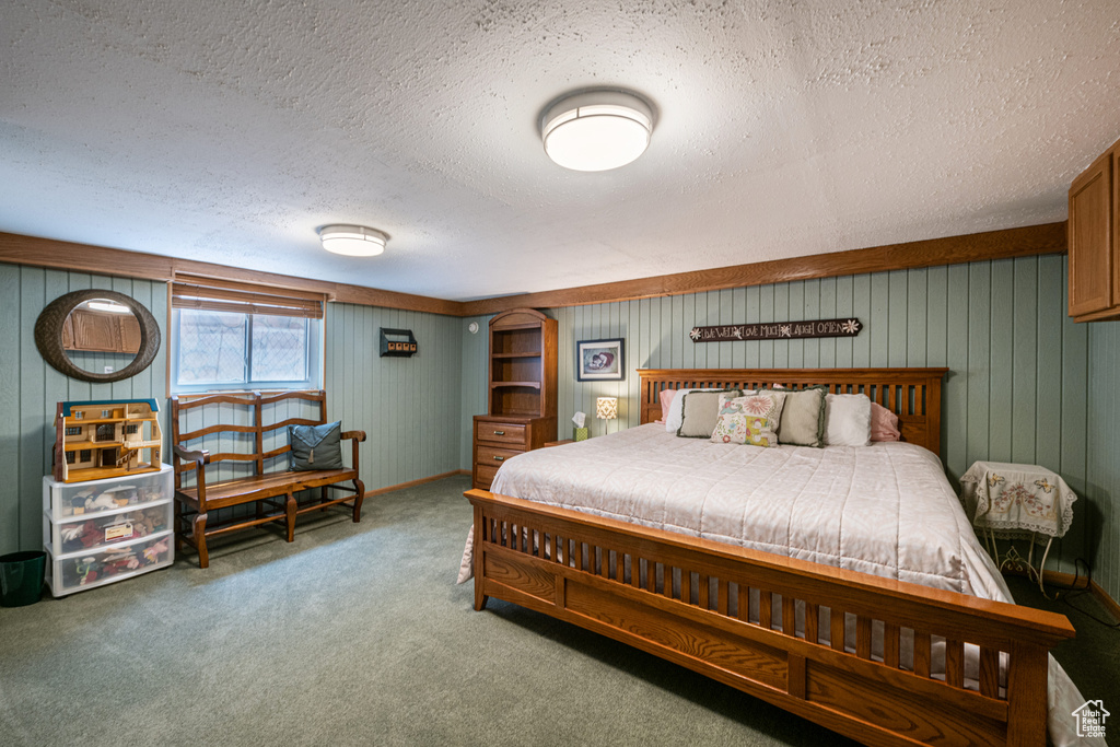 Bedroom featuring carpet and a textured ceiling