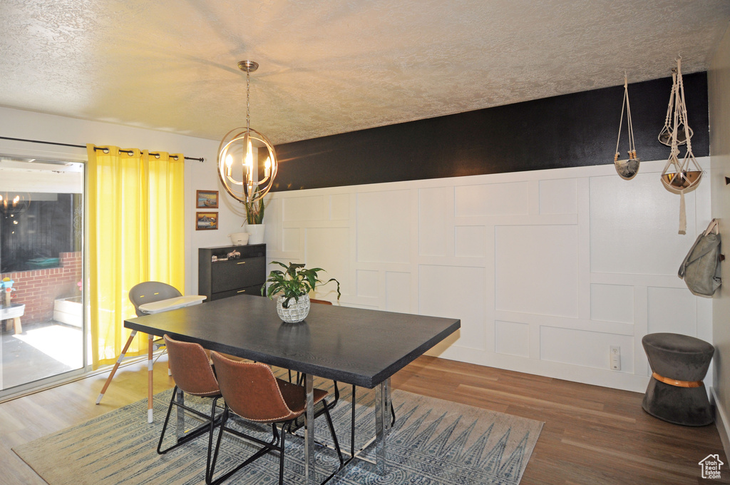 Dining space featuring a chandelier and hardwood / wood-style flooring