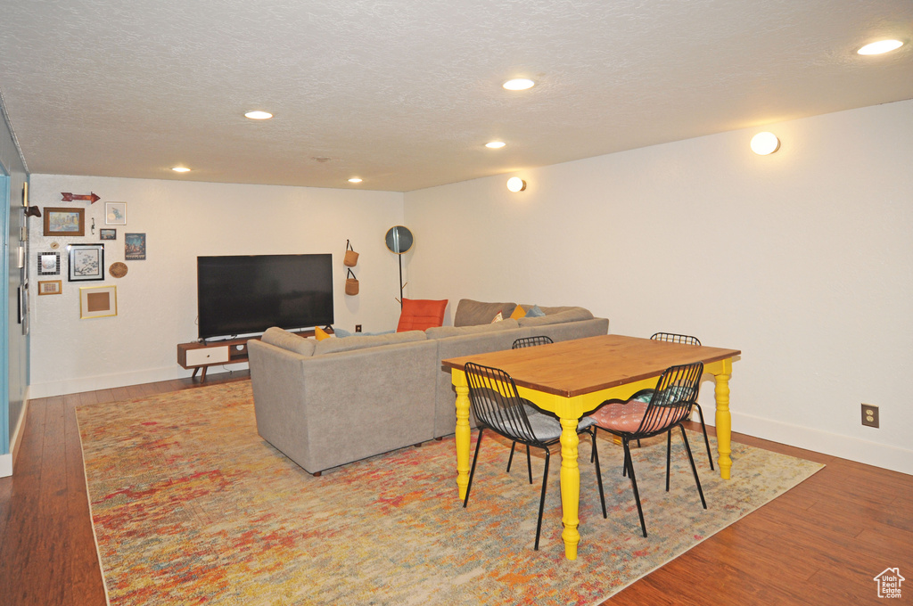 Dining area featuring wood-type flooring and a textured ceiling