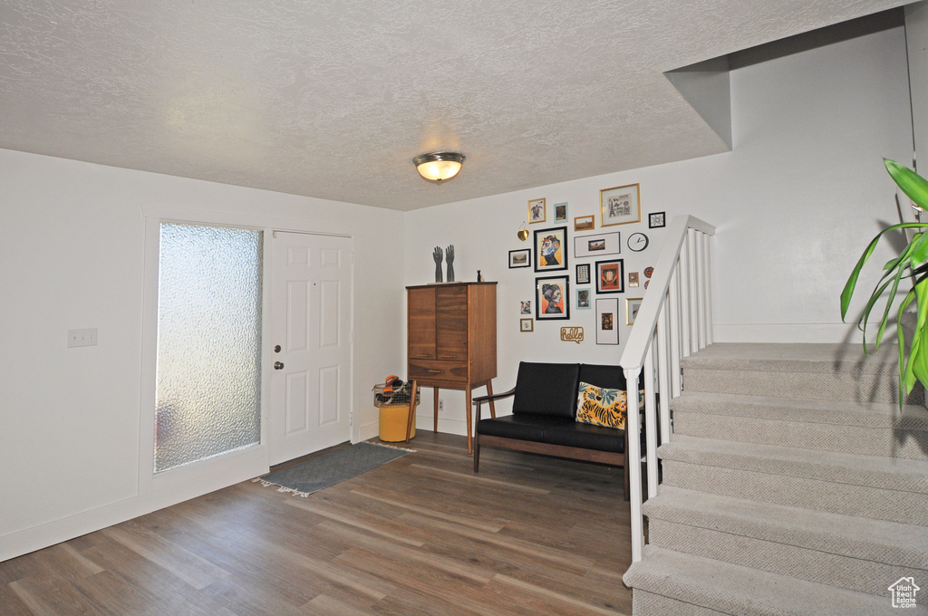 Entrance foyer with hardwood / wood-style flooring and a textured ceiling