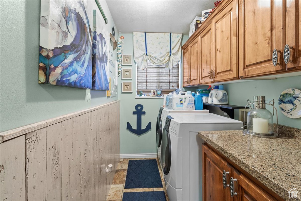 Washroom with cabinets, tile patterned flooring, and washer and dryer