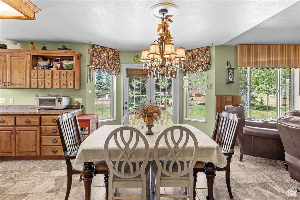 Tiled dining area with a notable chandelier