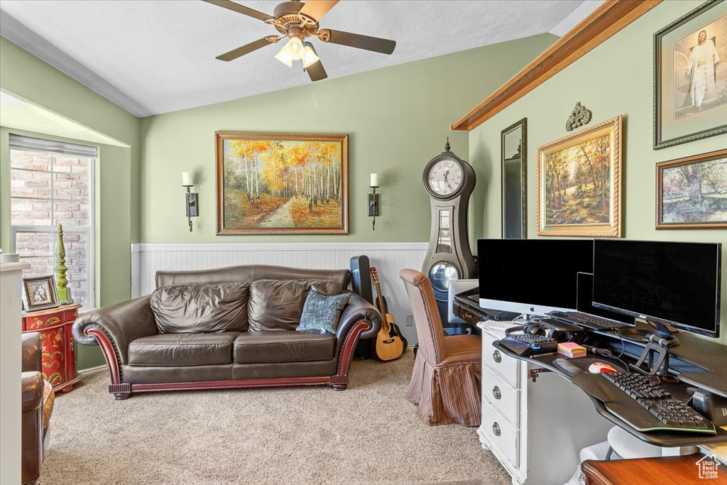 Office area with ceiling fan, lofted ceiling, and carpet flooring