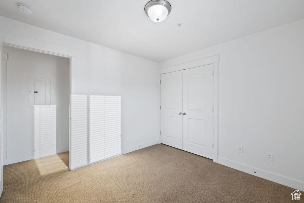 Unfurnished bedroom featuring carpet and a closet