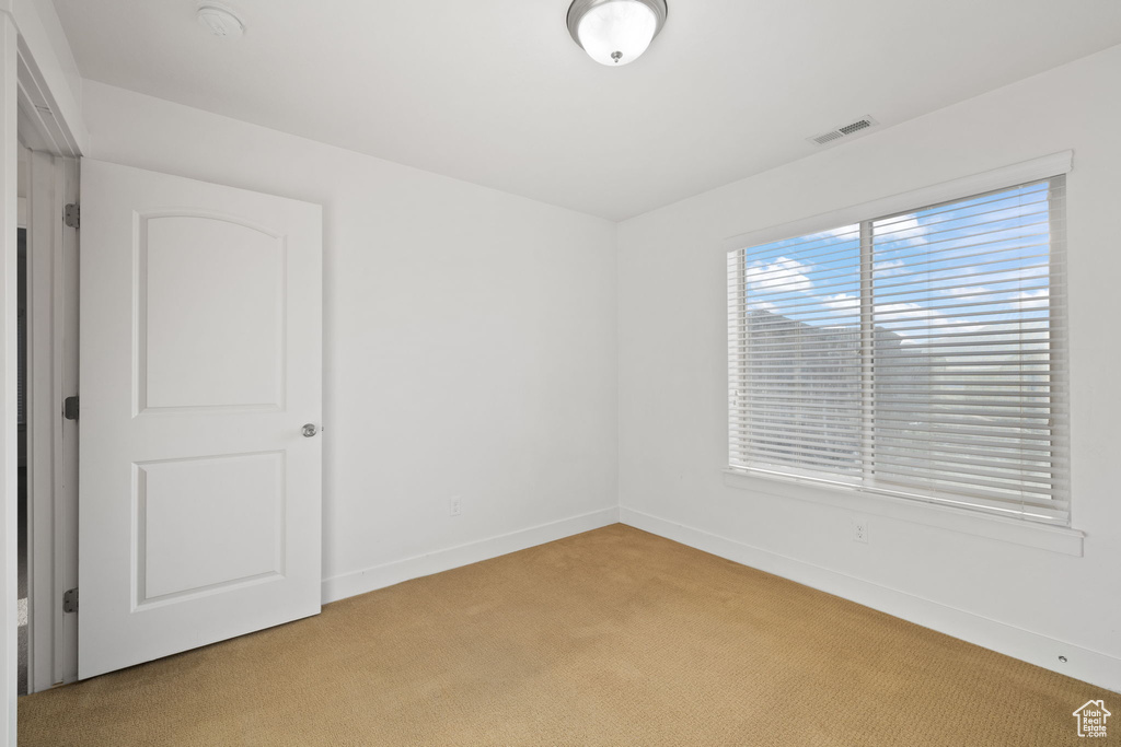 Spare room featuring light colored carpet