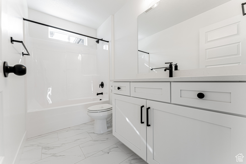 Full bathroom featuring toilet, vanity, and shower / bathing tub combination