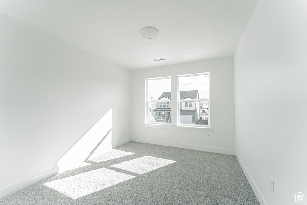 Spare room featuring light colored carpet