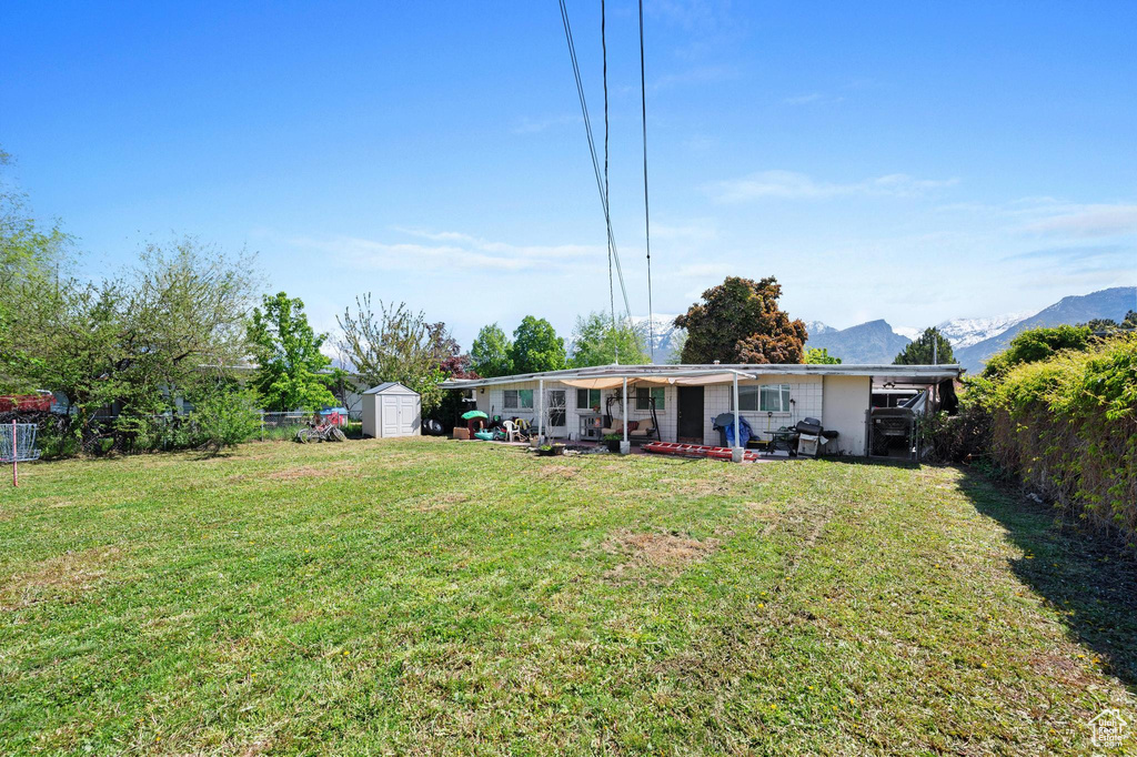 View of yard with a storage shed and a mountain view