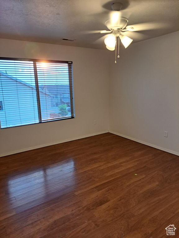 Empty room with hardwood / wood-style flooring and ceiling fan