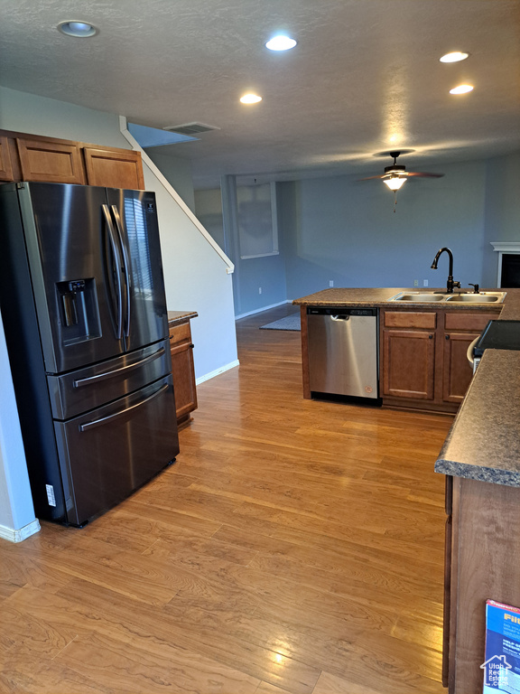 Kitchen featuring light hardwood / wood-style flooring, sink, dishwasher, ceiling fan, and black refrigerator with ice dispenser