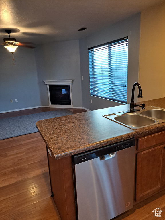 Kitchen with dishwasher, light hardwood / wood-style floors, sink, and ceiling fan