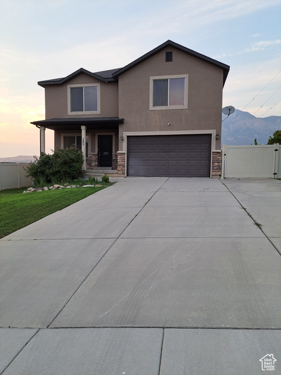 View of front of home featuring a garage and a mountain view