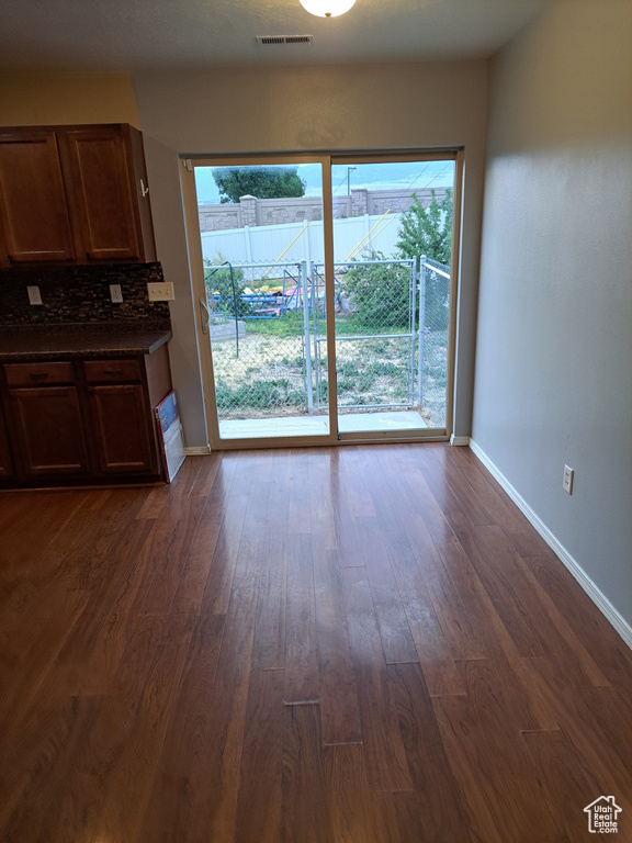 Interior space with plenty of natural light and dark hardwood / wood-style floors