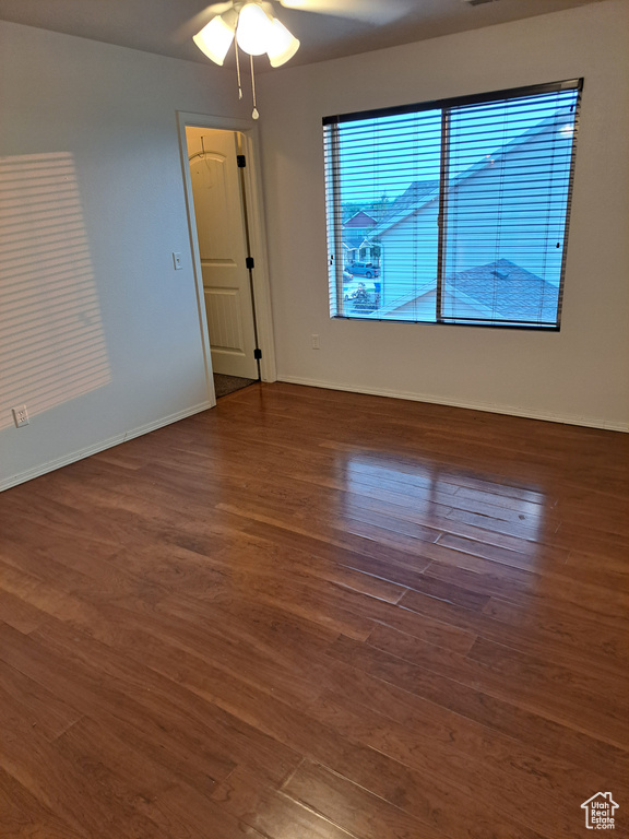 Unfurnished room with ceiling fan and hardwood / wood-style floors