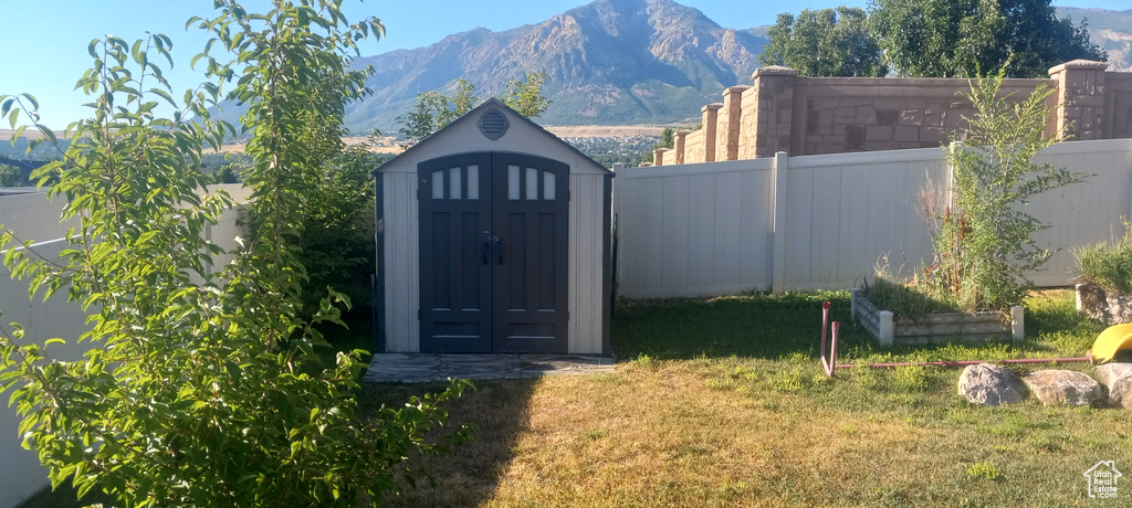 View of outdoor structure featuring a mountain view and a yard