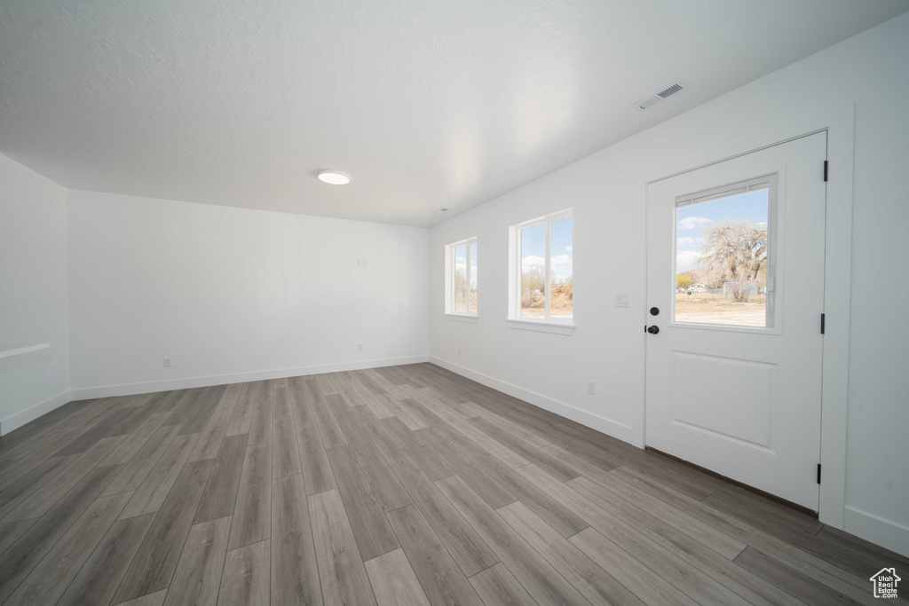 Entrance foyer with hardwood / wood-style flooring