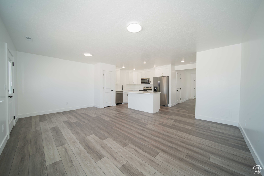 Unfurnished living room featuring light hardwood / wood-style floors