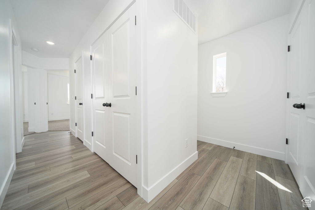 Corridor featuring light wood-type flooring